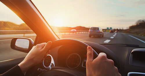 hands of car driver on steering wheel, road trip, driving on hig