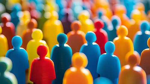 This vibrant image features a multitude of abstract figures in various colors against a blurred multicolored background, representing concepts of diversity, community, teamwork, and unity. The arrangement suggests a lively gathering, ideal for conveying messages related to social dynamics and inclusivity.