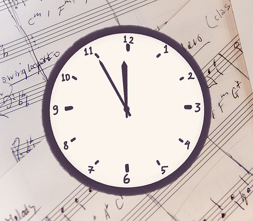 Uhr zeigt 11:55 Uhr, im Hintergrund Notenblätter mit handschriftlichen Notizen.