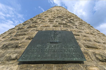 Bronzetafel an einem steinernen Turm mit der Inschrift zur Geburt von Kaiser Heinrich II. am 6. Mai 973 in Bad Abbach.